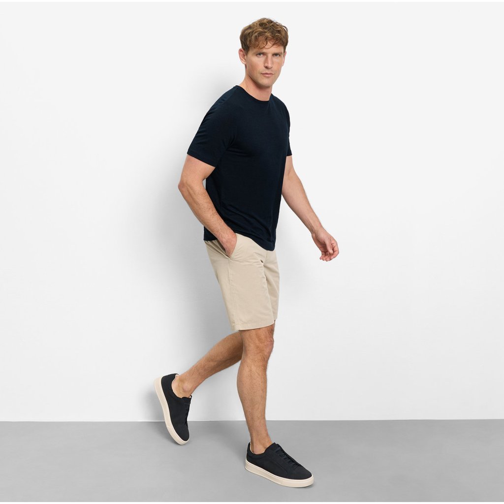 Styling modrého trička OLYMP so sivými bermudami a bielymi teniskami